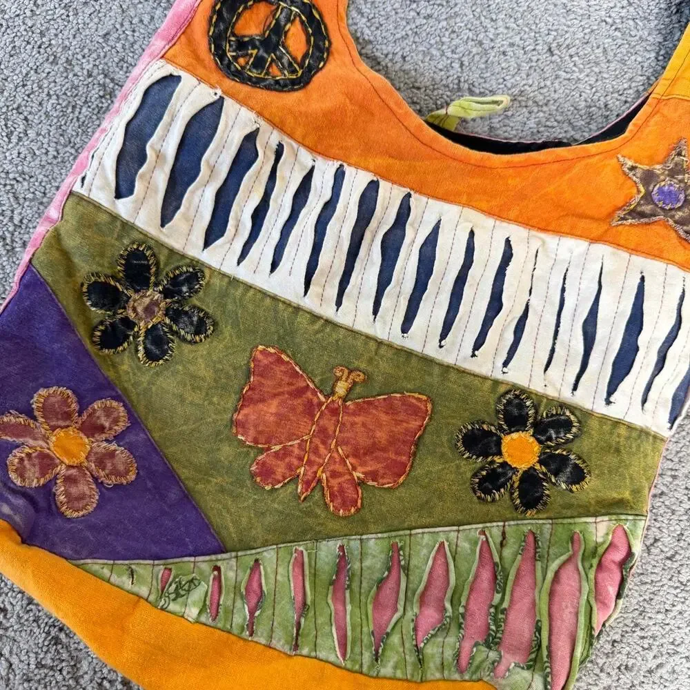 Patchwork hippie style bag with peace sign, star, and floral appliqués